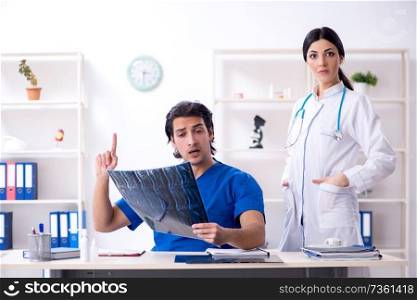 Two young doctors working in the clinic 