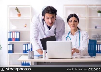 Two young doctors working in the clinic 