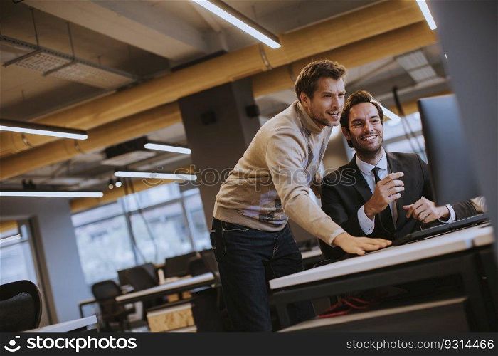 Two young employees working in the modern office