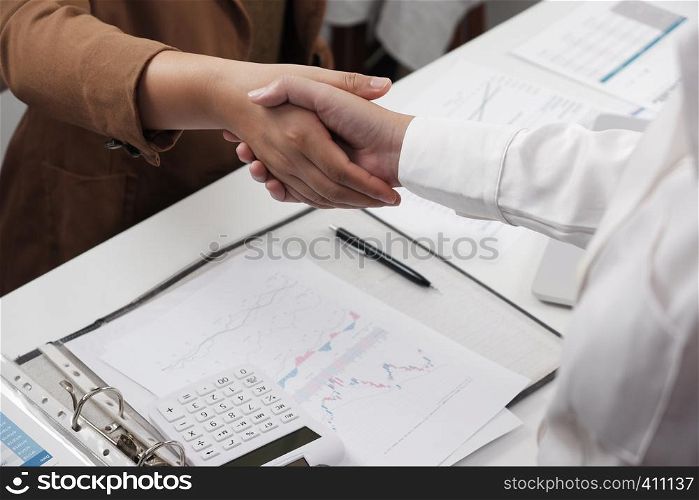 two young female professional shaking hand business concept