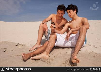 Two young friends relaxing at the beach