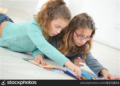 Two young girls drawing