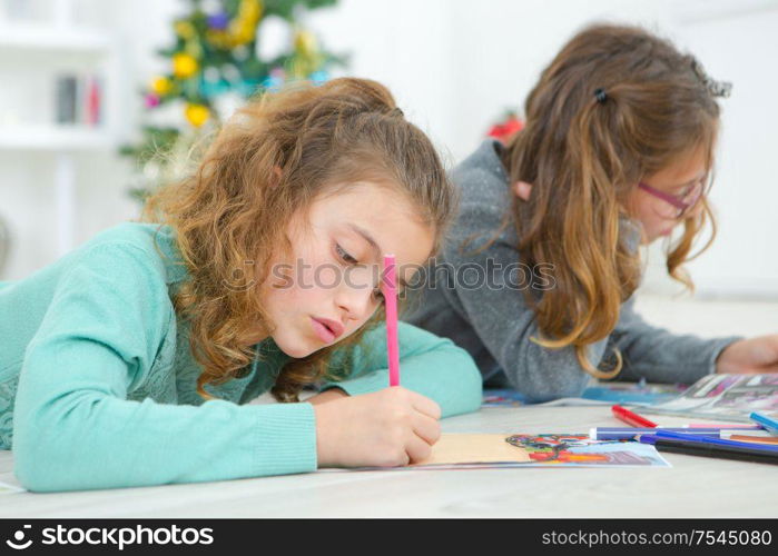 Two young girls drawing