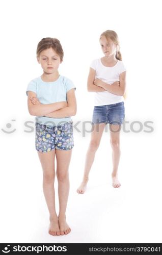 two young girls having a disagreement in studio with white background