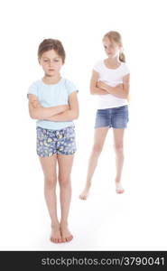 two young girls having a disagreement in studio with white background