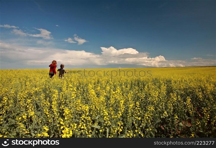 Two young girls in a canola field