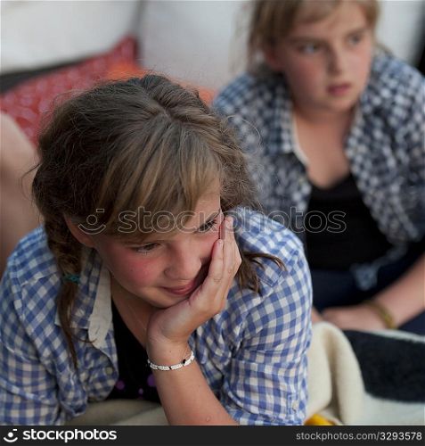Two young girls looking off into the distance