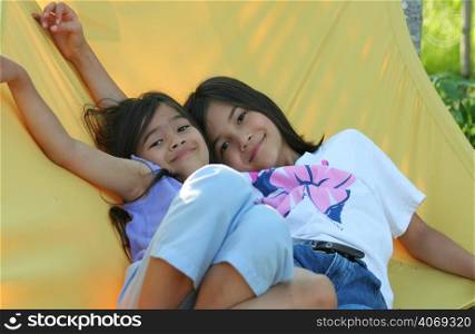 Two young girls on a hammock