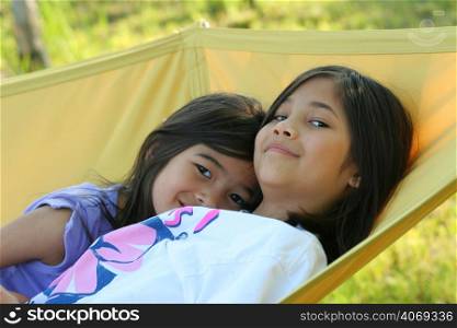 Two young girls on a hammock