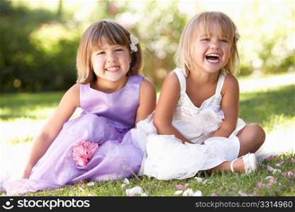 Two young girls posing in park