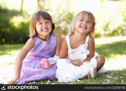 Two young girls posing in park