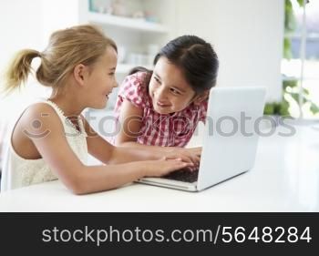 Two Young Girls Using Laptop At Home