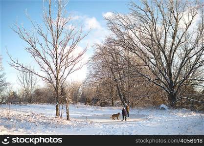 Two young girls with dog in snowy landscape