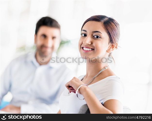 Two young happy collegues in offfice