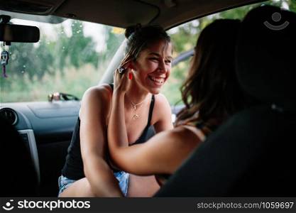 Two young lesbians enjoying inside a car, lgbti concept