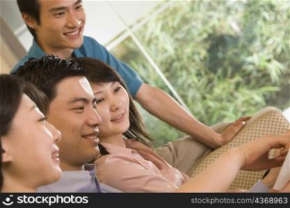 Two young men and two young women sitting together and smiling