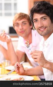 Two young men eating a meal