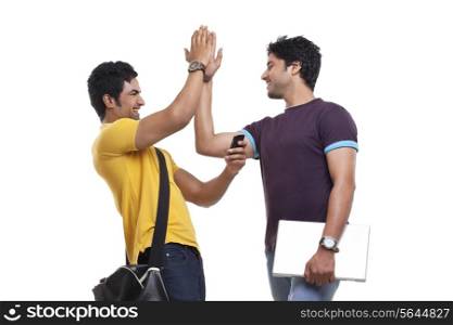 Two young men giving high-five