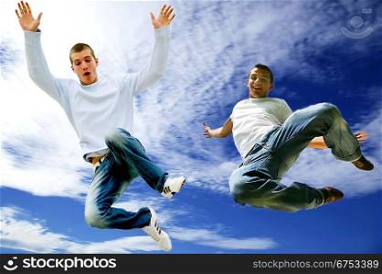 Two young men jumping in the air