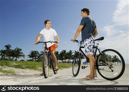 Two young men on bicycles