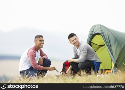 Two Young Men On Camping Trip In Countryside