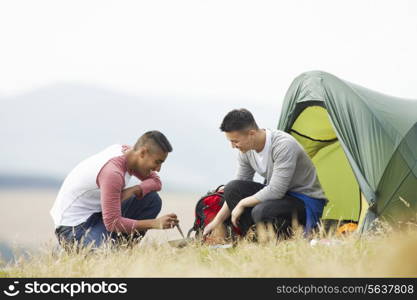 Two Young Men On Camping Trip In Countryside