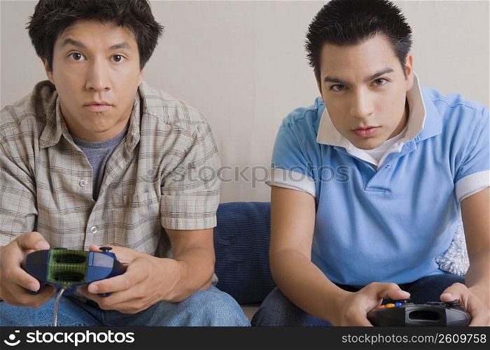 Two young men playing video game