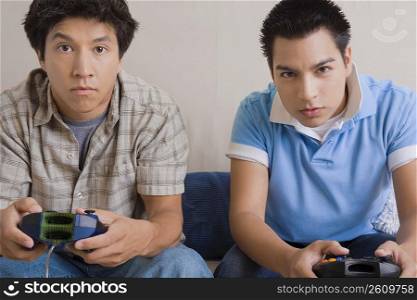 Two young men playing video game