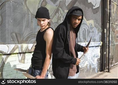 Two young men posing with knives