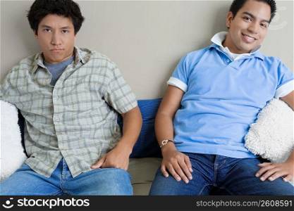 Two young men sitting on a couch