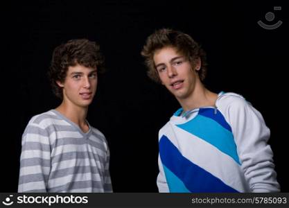 two young men standing, on a black background