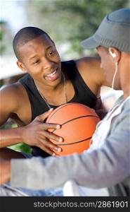 Two Young Men with Basketball, Talking