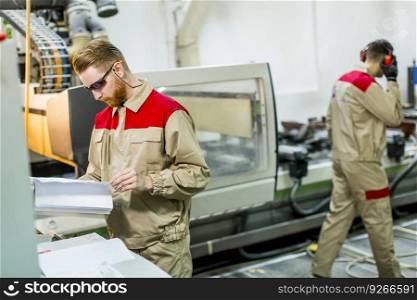 Two young men working in the furniture factory