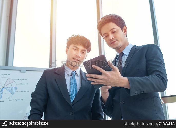 Two young multiracial group businessmen working in modern workplace with technology office.Business and finance concept.