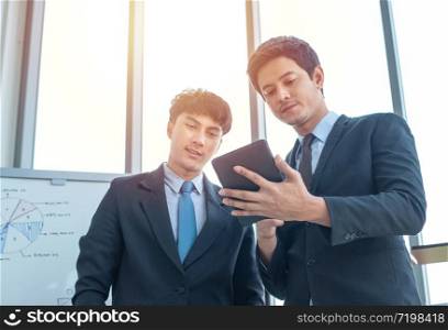 Two young multiracial group businessmen working in modern workplace with technology office.Business and finance concept.