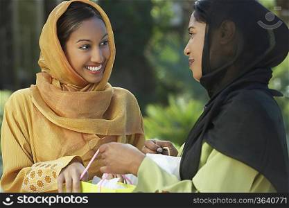 Two young muslim women talking outdoors