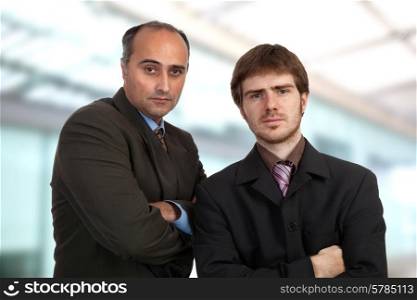 two young pensive business men portrait standing