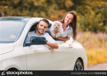 Two young people enjoy summer vacation. Happy couple tourists look from car. Young couple tourist enjoying on summer vacation