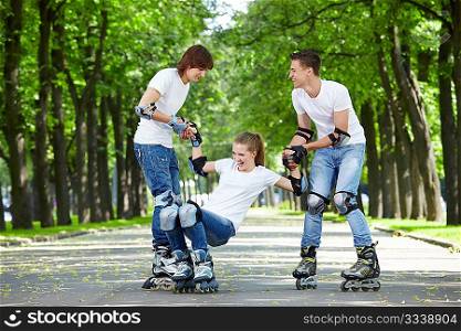 Two young people lift the fallen girl on rollers