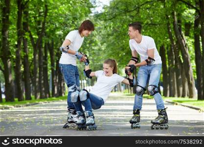 Two young people lift the fallen girl on rollers
