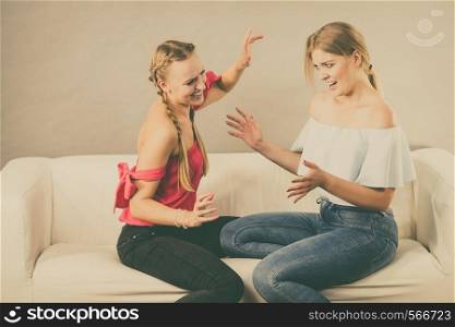 Two young pretty women being mad at each other after argue of fight. Friendship rivaly and envy problems.. Two women having bad discussion