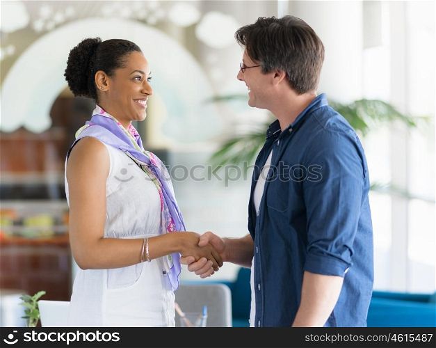 Two young professionals shaking hands