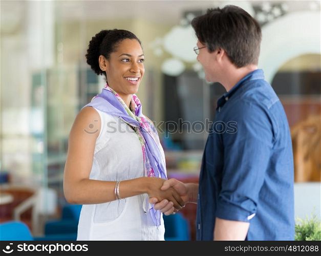 Two young professionals shaking hands