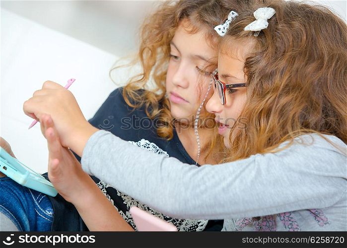 Two young sisters playing video gales