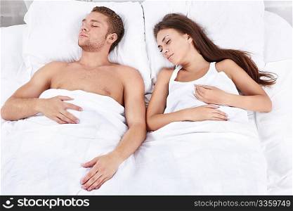 Two young sleeping in bed