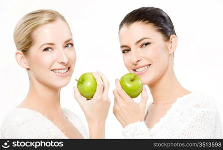 two young smiling caucasian women holding apples