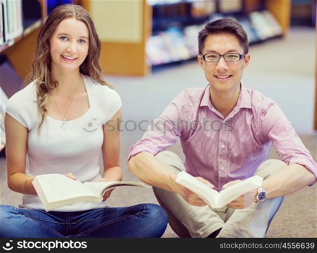 Two young students at the library. Two young students working together at the library