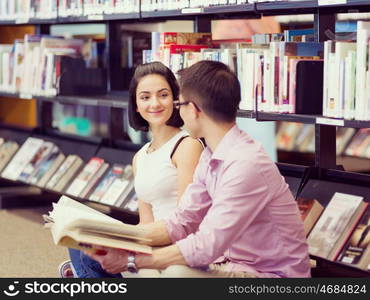 Two young students at the library. Two young students working together at the library