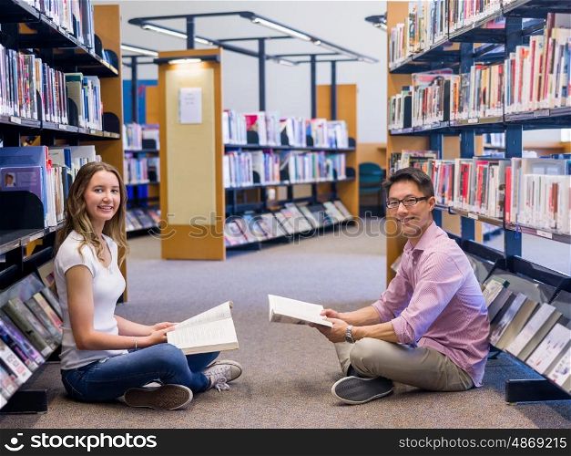 Two young students at the library. Two young students working together at the library