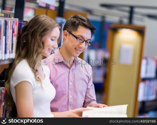 Two young students at the library. Two young students working together at the library